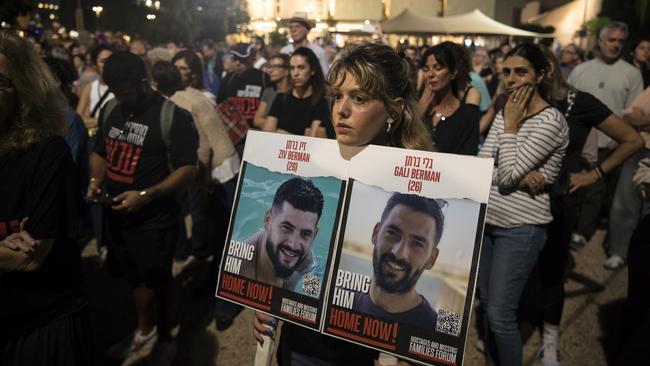 A woman holds a photo of hostages during the moment of silence in Tel Aviv to mark the month since the October 7 Hamas attacks. Picture: Getty Images