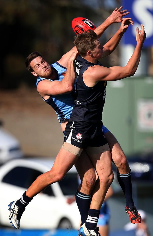 South Adelaide’s Sam Overall competes with Sturt's Fraser Evans in a marking contest. Picture Dean Martin