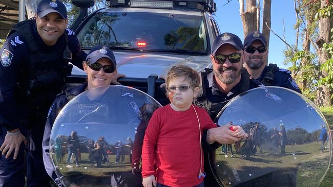 QPS Officers (Public Safety Response Team) Russell Satour, Alison Schulze, Aaron Izzard and Jason Butler with Slater Clifton-Walker on his Hero Day fundraiser for brain cancer research