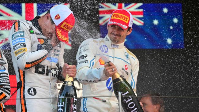 Winning driver McLaren's British driver Lando Norris, left, is sprayed with champagne by second-placed Ferrari's Monegasque driver Charles Leclerc on the podium at the Formula One Monaco Grand Prix at the Circuit de Monaco. (Photo by Andrej ISAKOVIC / AFP)