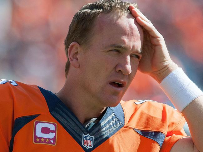 DENVER, CO - OCTOBER 5: Quarterback Peyton Manning #18 of the Denver Broncos wipes his brow before the start of a game against the Arizona Cardinals at Sports Authority Field at Mile High on October 5, 2014 in Denver, Colorado. Dustin Bradford/Getty Images/AFP == FOR NEWSPAPERS, INTERNET, TELCOS & TELEVISION USE ONLY ==