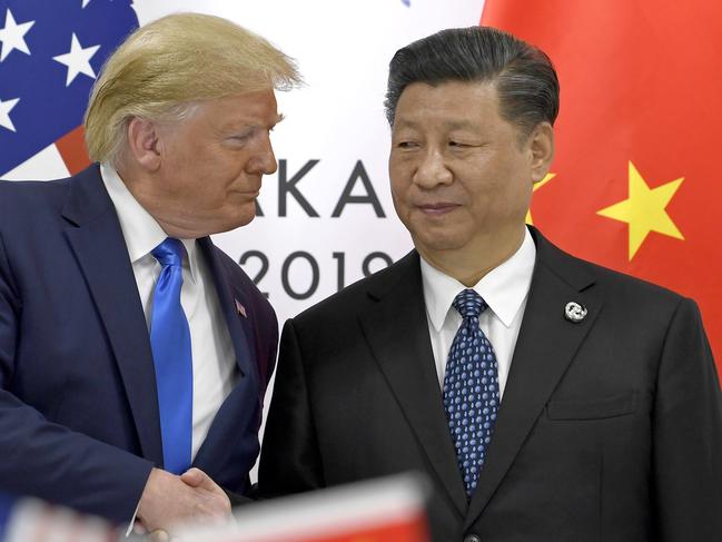 FILE - In this  June 29, 2019, file photo, U.S. President Donald Trump, left, shakes hands with Chinese President Xi Jinping during a meeting on the sidelines of the G-20 summit in Osaka, western Japan. Facing another U.S. tariff hike, Xi is getting tougher with Washington instead of backing down. Both sides have incentives to settle a trade war that is battering exporters on either side of the Pacific and threatening to tip the global economy into recession. (AP Photo/Susan Walsh, File)