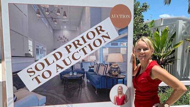 Joanne Marek of Marek Realty puts the SOLD sign up at 2/25 Edward St, Noosaville, ahead of Saturday's scheduled auction.