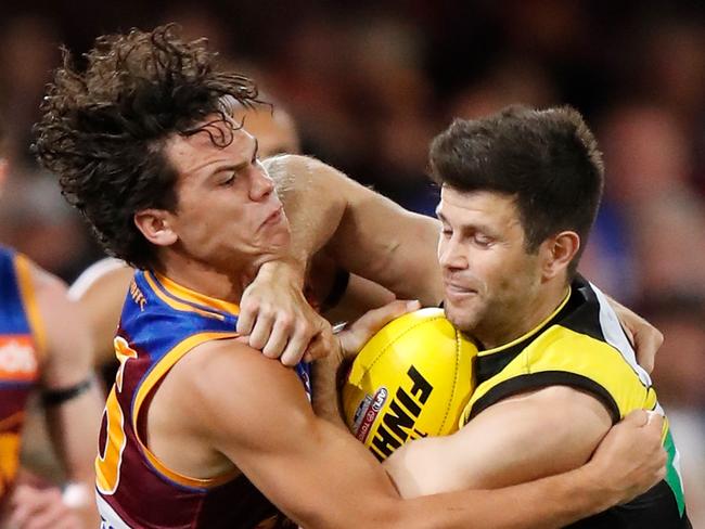 BRISBANE, AUSTRALIA - SEPTEMBER 07: Trent Cotchin of the Tigers is tackled by Cam Rayner of the Lions during the 2019 AFL Second Qualifying Final match between the Brisbane Lions and the Richmond Tigers at The Gabba on September 07, 2019 in Brisbane, Australia. (Photo by Michael Willson/AFL Photos via Getty Images)