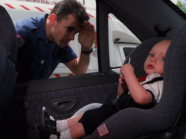 7.1.97 Kids left in hot cars. Ambulance officer Dave Ferrari looks in on Christopher Thiveos. p/./ambulance