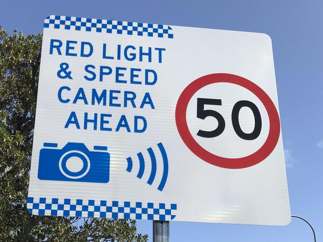 A speed and red light camera warning sign.
