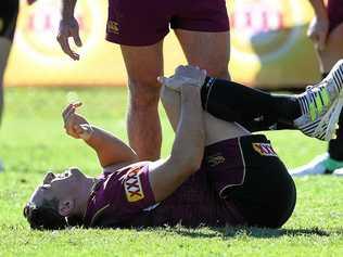 INJURY CONCERN: Maroons fullback Billy Slater grimaces after rolling his ankle during the Queensland State of Origin team training session at Sanctuary Cove. Picture: DAVE HUNT