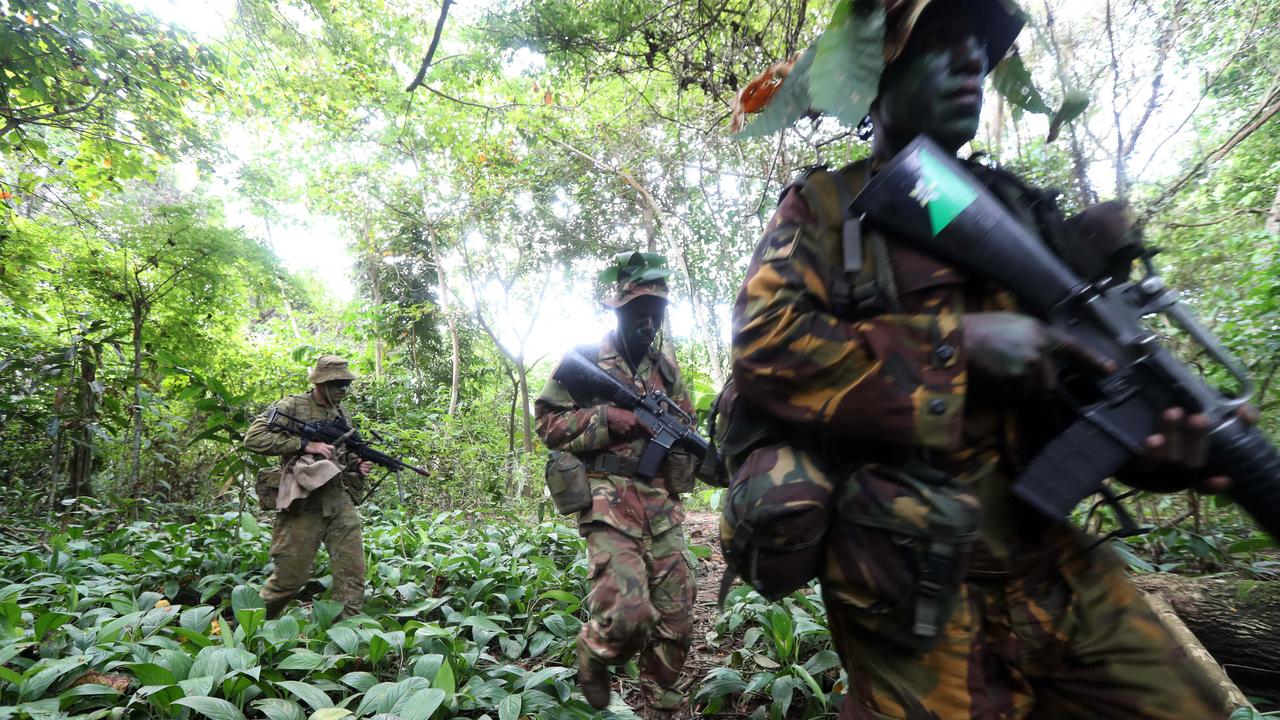 Aussie diggers with PNG soldiers during an exercise in jungle warfare. Picture Gary Ramage