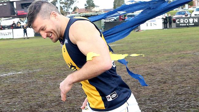 Daniel Keenan runs through the banner for his 400th game. Picture: Hamish Blair