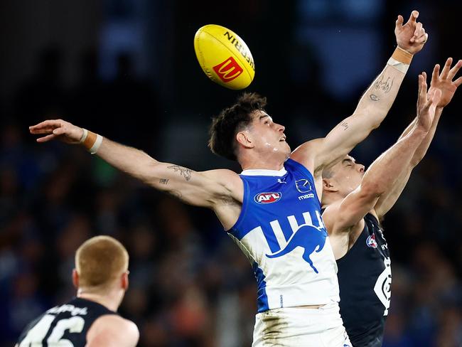 Zac Fisher of the Kangaroos and Matthew Kennedy of the Blues compete for the ball. Picture: Michael Willson/AFL Photos via Getty Images.