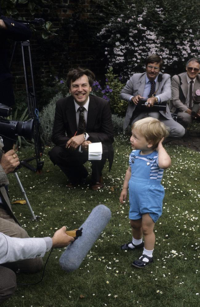 A young Prince William checks out a camera as he attends a photocall for his second Birthday in the gardens of Kensington Palace in 1984. Picture: Anwar Hussein/Getty