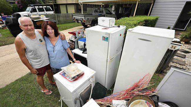 Paul and Kerri Ross with ruined household goods after their home was flooded.