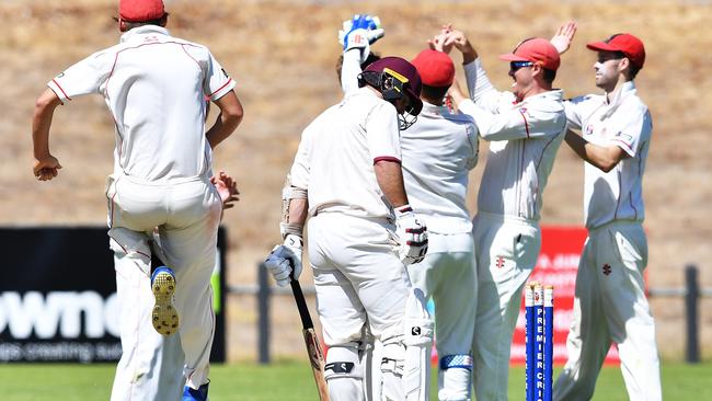 CELEBRATION TIME: Adelaide players celebrate the key wicket of Tea Tree Gully’s Adam Somerfield in the semi-final at Pertaringa Oval. Picture: MARK BRAKE (AAP).