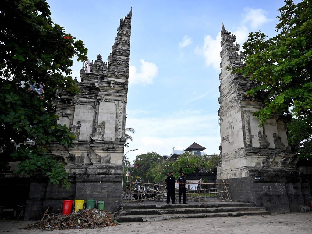 Balinese security employees stand by a closed-off entrance gate leading to a beach amid the COVID-19 pandemic near Denpasar. Picture: Sonny Tumbelaka/AFP