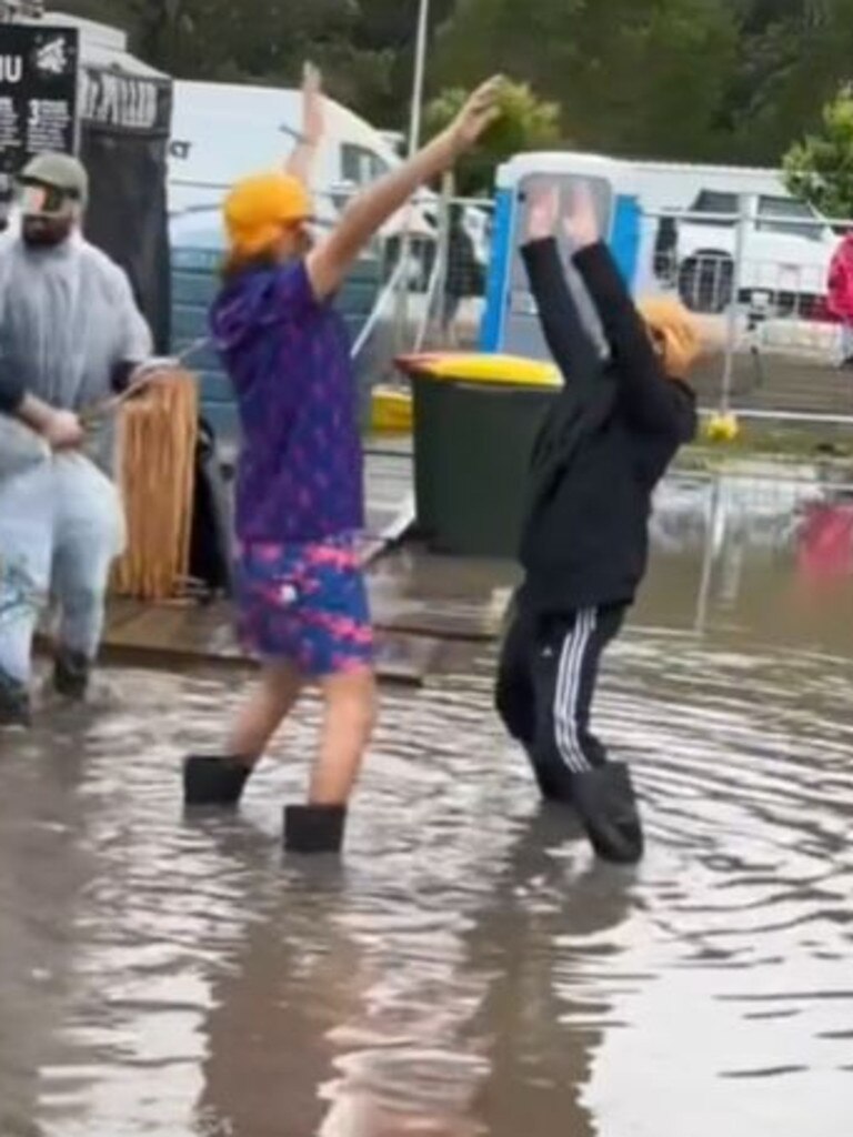 Two people danced in the muddy water at Splendour. Picture: TikTok/@jaydenblochmusic