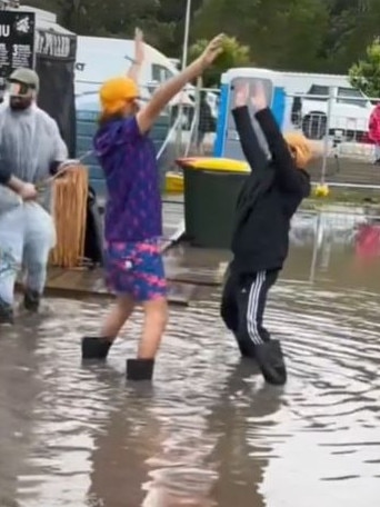 Two people danced in the muddy water at Splendour. Picture: TikTok/