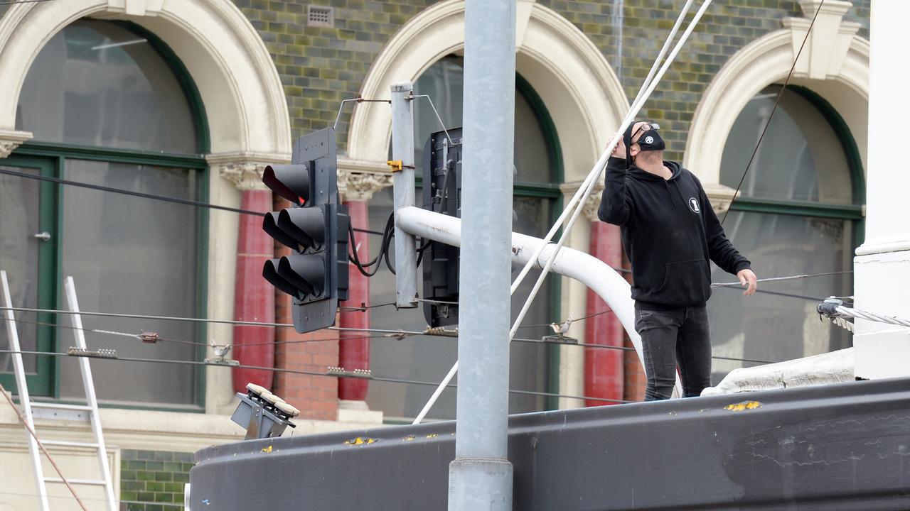 A person inspects for damage at a building on the corner of Chapel and High streets. Picture: Andrew Henshaw