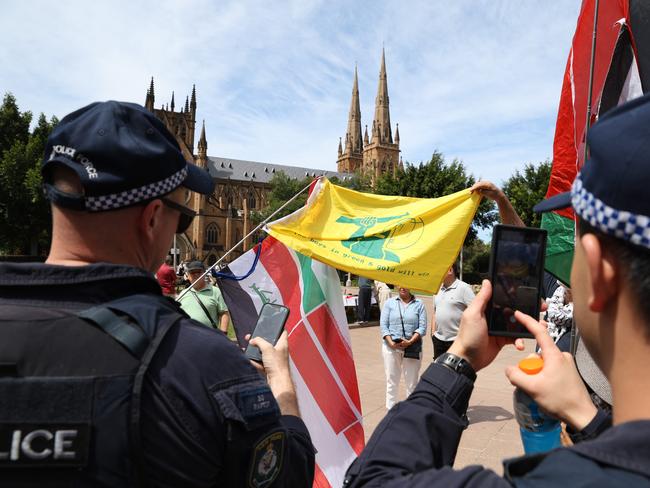 A protester pictured holding a yellow flag similar to the Hezbollah flag, but instead depicting bushranger Ned Kelly. Picture: NewsWire / Damian Shaw