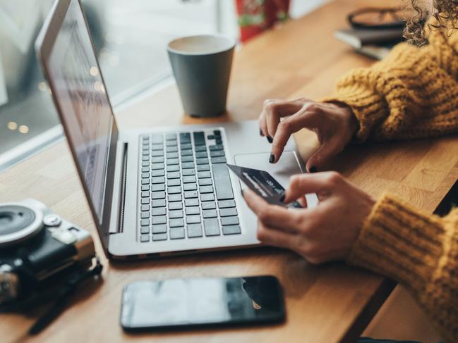 Woman in cafe shopping online with laptop