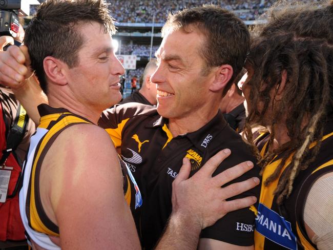 Shane Crawford embraces coach Alastair Clarkson.