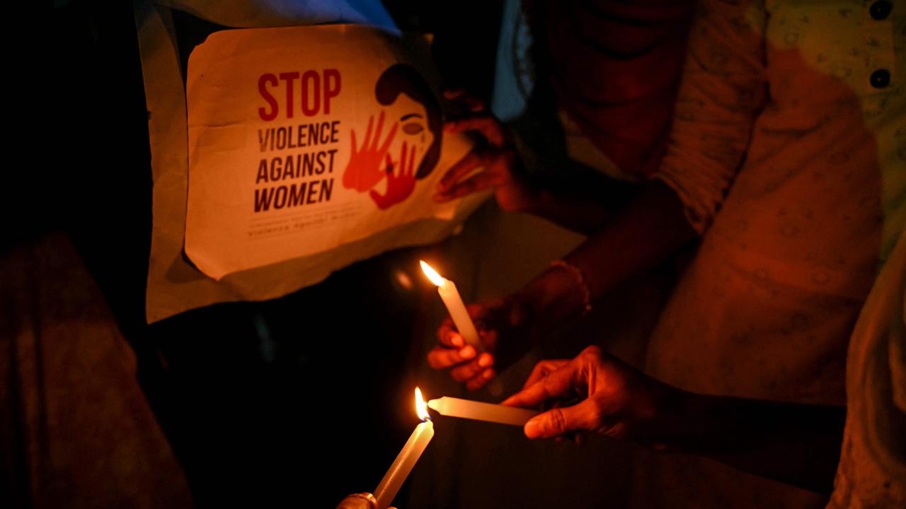 Doctors hold posters during a candlelight march on August 20 amid a nationwide strike to condemn the rape and murder of a doctor in India's West Bengal state. Picture: R Satish Babu/AFP