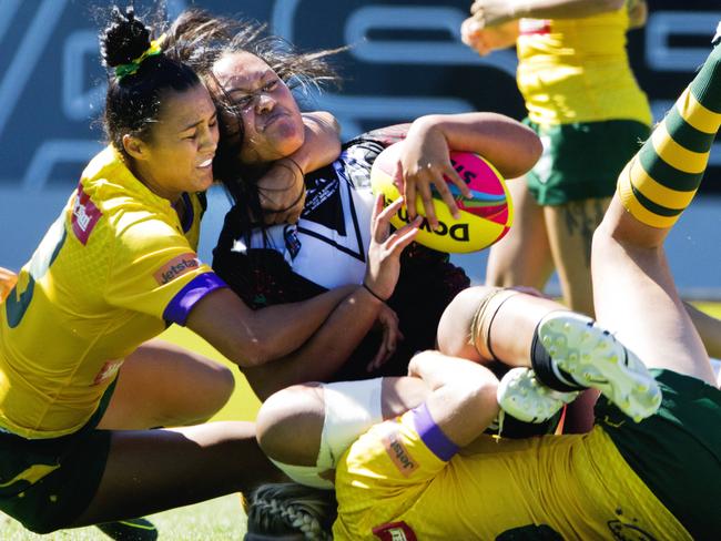 Jillaroos players take down a Kiwi Fern. Pic Jenny Evans