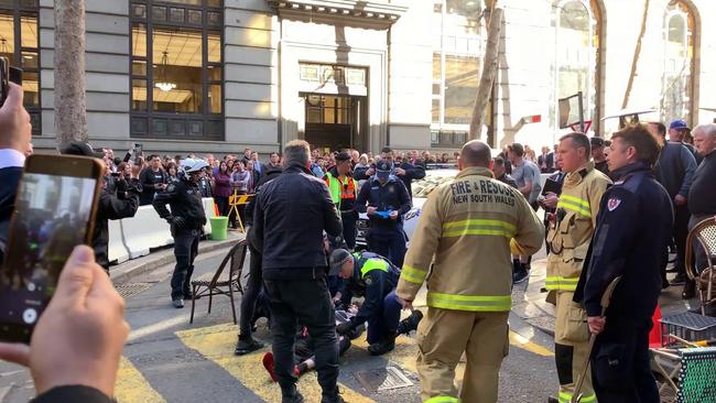 A large crowd gathers as Ney is arrested near Clarence Street. Picture: Marc Kean