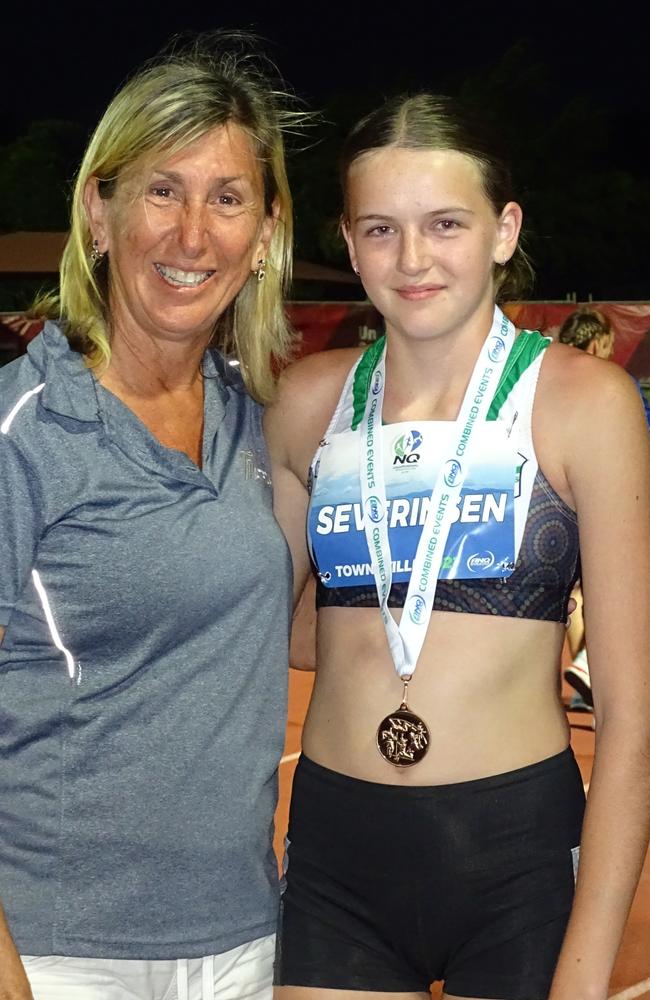 Ipswich and District Athletic Club achiever Abbie Severinsen receives her medal from 1984 Olympic heptathlon gold medallist Glynis Nunn. Picture: Vic Pascoe