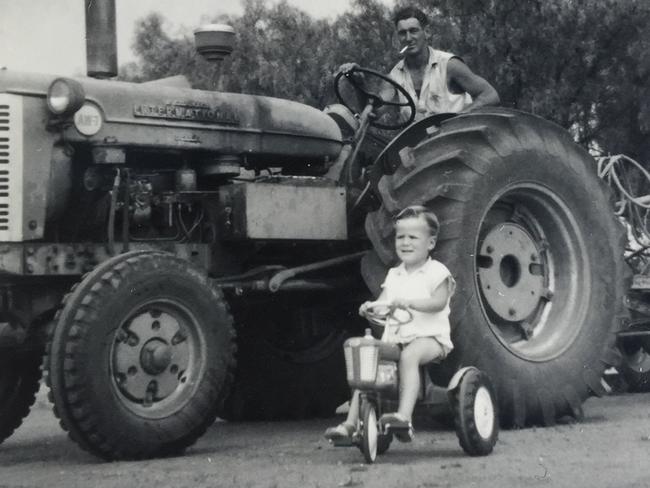 Mr McCormack gets rolling as a three-year-old beside his father, Lance, in 1968.