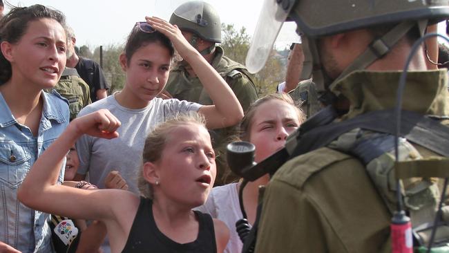 This photo from 2012 shows Ahed Tamimi gesturing in front of an Israeli soldier during a protest.
