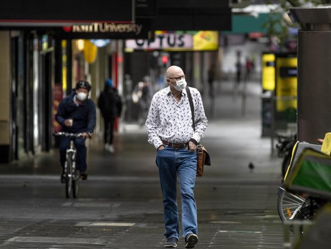 MELBOURNE, AUSTRALIA - NewsWire Photos October 13 2020: A man walks along a deserted Bourke st in the CBD on Tuesday morning during stage 4 restrictions in Melbourne.Picture: NCA NewsWire / David Geraghty