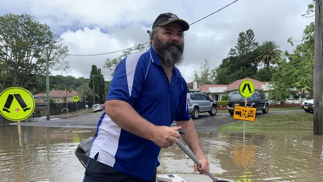 Fowler Street resident Max Walker paddles past his flood filled home on March 1, 2022, a day after Lismore was hit by a record flood. Picture: Stuart Cumming