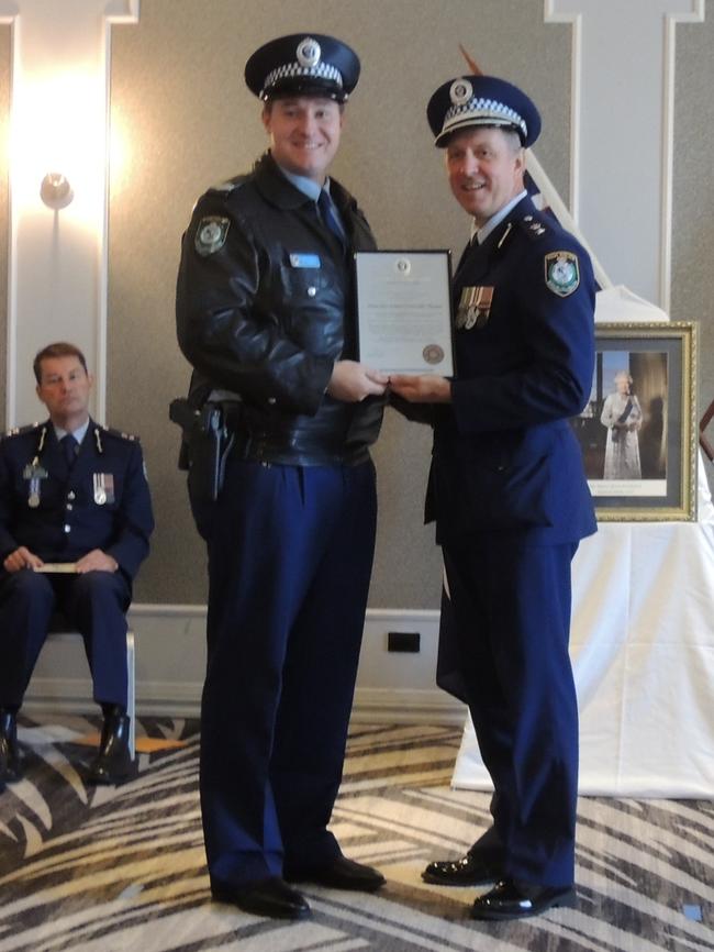 Sgt Evan Davies receives a Local Area Commander's Commendation from Acting Supt Aprad Szabo