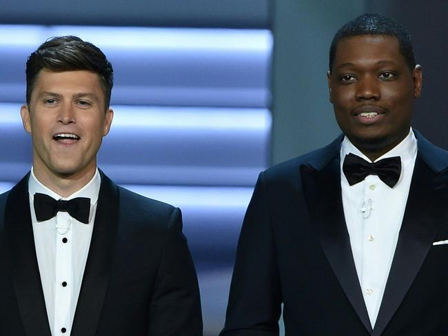 Host Colin Jost (L) and Michael Che speak onstage during the 70th Emmy Awards at the Microsoft Theatre in Los Angeles, California on September 17, 2018. (Photo by Robyn BECK / AFP)