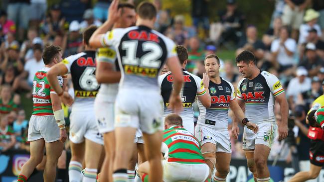 Trent Merrin celebrates with his Panthers teammates after scoring a try.