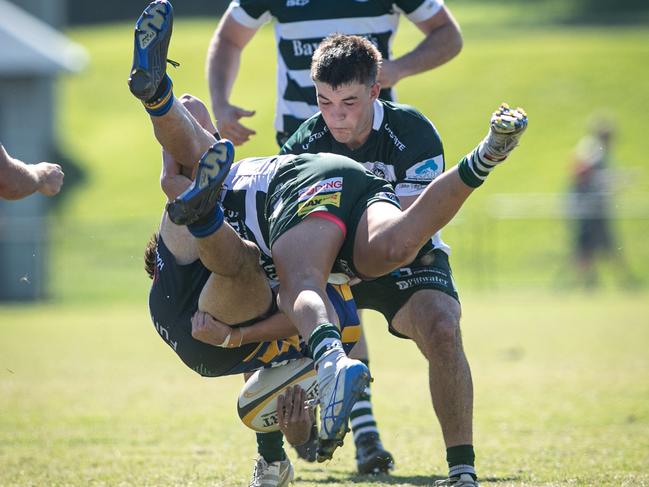 19/04/25. News Local. Sport. Warriewood, Sydney, NSW.Pics by Julian Andrews.Action pictures from the 1st Colts match between Warringah vs Sydney Uni at Pittwater Rugby Park, Warriewood.Pic shows:Warringah player: Sydney Uni player: Dane Mitchell gets upended