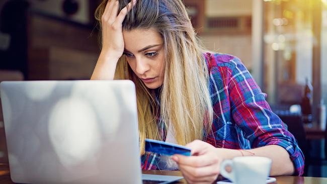 Young girl have problems with her credit card till shopping online. istock photo