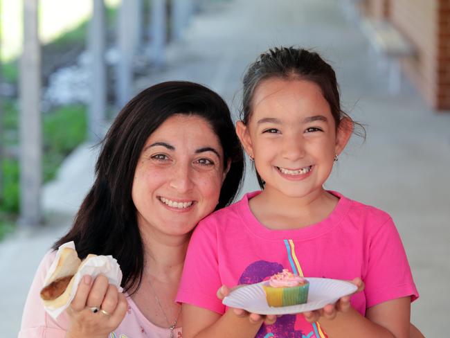 Tamara Russo and daughter Adriana Russo, 6 enjoying a cake and a democracy sausage in the 2019 State Election. Pic: Craig Wilson