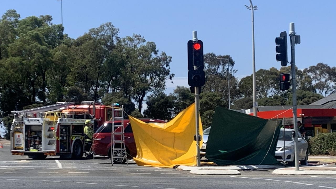 Police and paramedics at the intersection of Atlantis Drive and The Grove Way after a crash.