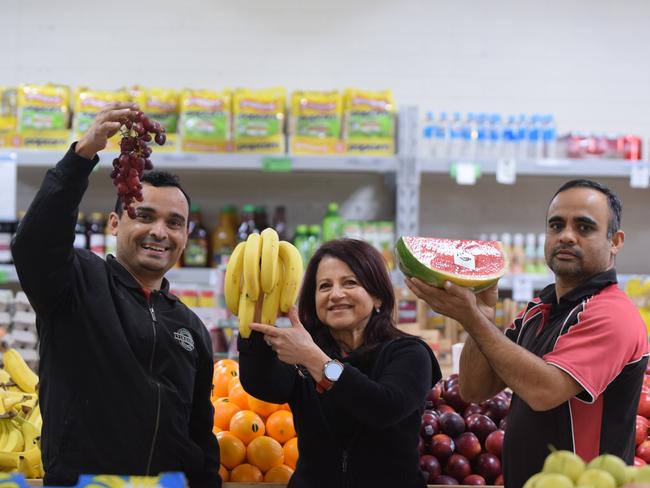 Mehul (left) and Pragnesh Patel with employee Carmela Rositano.