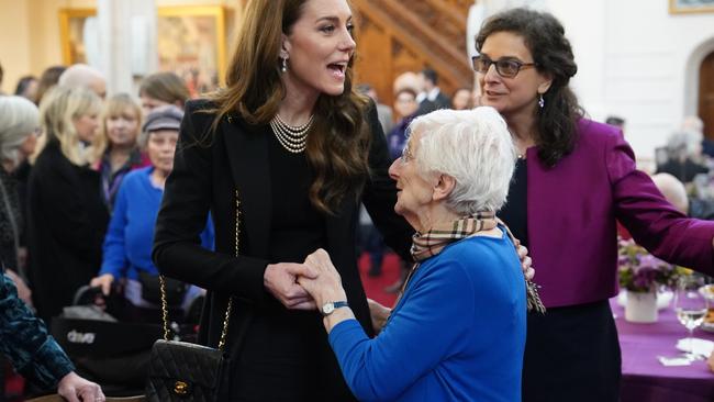 She was still toting the bag when she met with Holocaust survivors Yvonne Bernstein and Stephen Frank. Picture: Arthur Edwards – WPA Pool/Getty Images