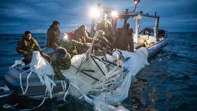 This picture provided by the US Navy shows sailors assigned to Explosive Ordnance Disposal Group 2 recover a high-altitude surveillance balloon off the coast of Myrtle Beach, South Carolina.