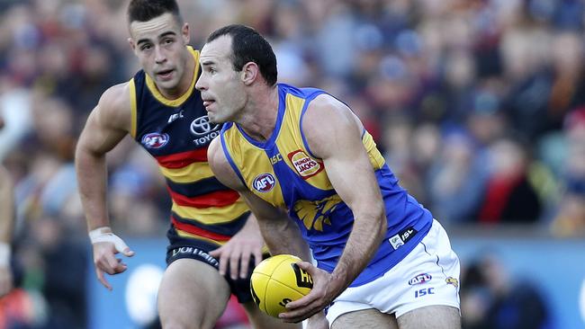 Shannon Hurn looks to pass with Myles Poholke behind30/06/18 - AFL - Adelaide Crows v West Coast Eagles - Round 15 at the Adelaide Oval. . Picture Sarah Reed