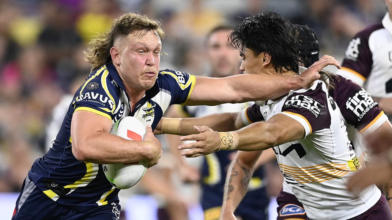 Reuben Cotter fends away from the Brisbane defence. (Photo by Ian Hitchcock/Getty Images)