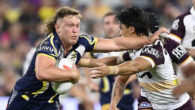 Reuben Cotter fends away from the Brisbane defence. (Photo by Ian Hitchcock/Getty Images)