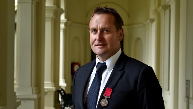 Detective Senior Constable Danny Shaddock with his bravery medal. Picture: Jay Town