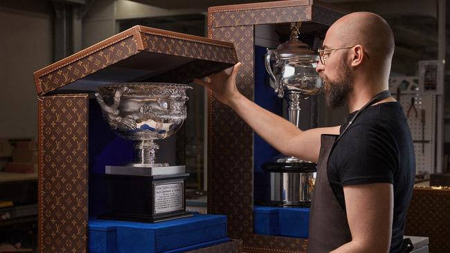 A Louis Vuitton artisan fitting one of the trophies into the trunk