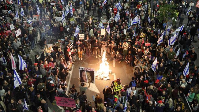 Relatives and supporters of Israeli hostages held in Gaza since the October 7 attacks by Hamas militants, hold placards and wave Israeli flags during a demonstration in front of the Defense Ministry in the coastal city of Tel Aviv, on March 23. Picture: Jack Guez/AFP