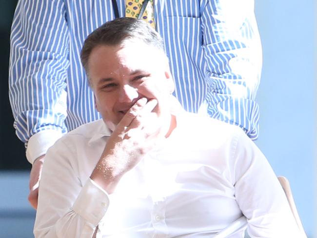 Jamie Briggs in a wheelchair arriving party room meeting at Parliament House in Canberra. Pic by kym Smith
