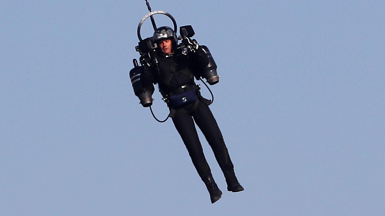 A man flies a jet pack at a 2018 Red Bull Air Race, a more appropriate location than near a commercial airport. Picture: Valery Hache / AFP